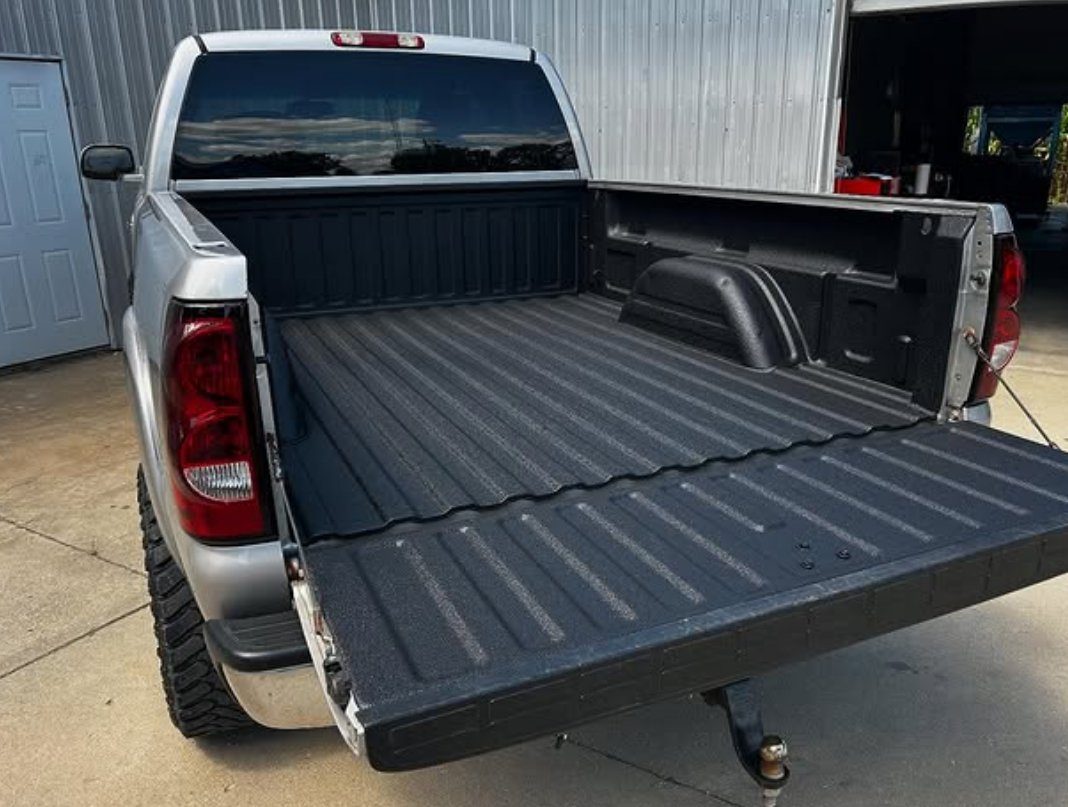 A finished spray-on bed liner with a clean textured surface