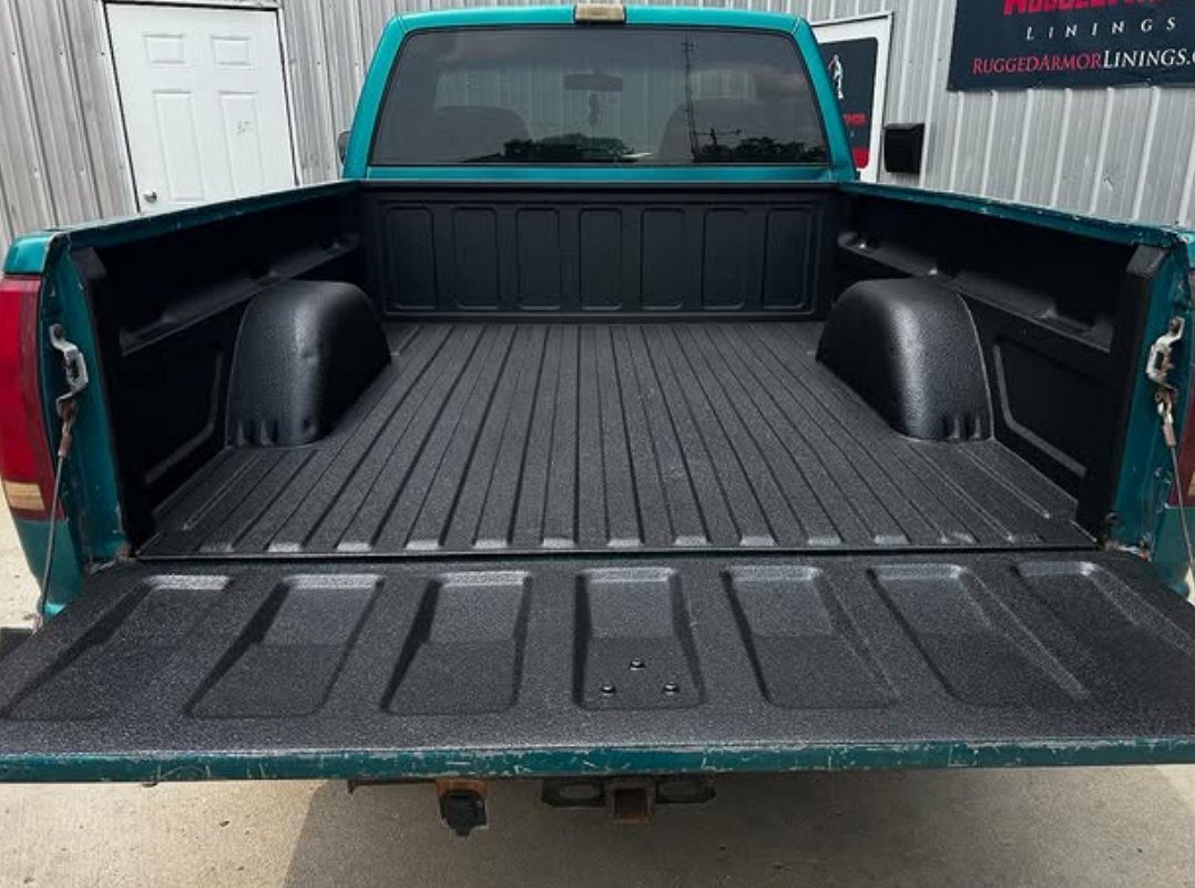 A truck bed after a black spray-on liner